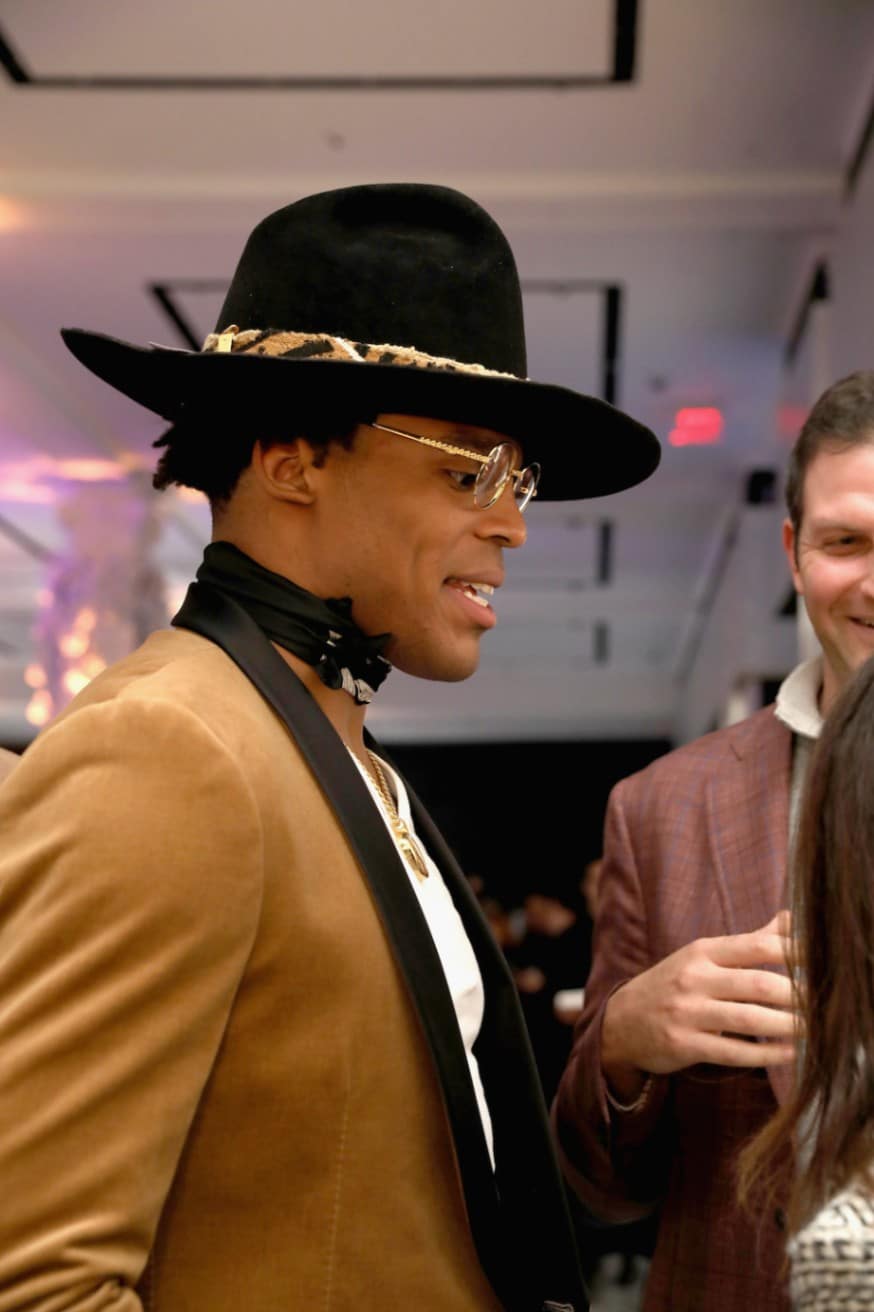 Cam Newton in a felt, drill sergeant hat with a leopard hat band. (Photo by Anna Webber/Getty Images for Saks Fifth Avenue)