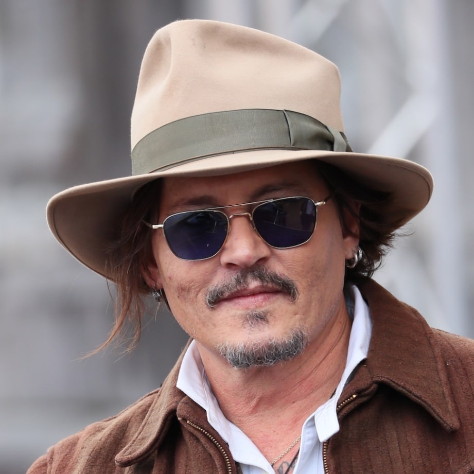 Johnny Depp wears a beige fedora at the San Sebastian Film Festival