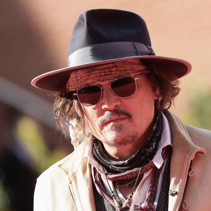 Johnny Depp wears a black fedora to the Puffins premiere