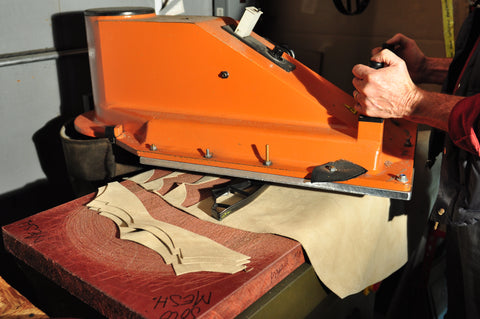 image of leather being cut using pre-shaped dies