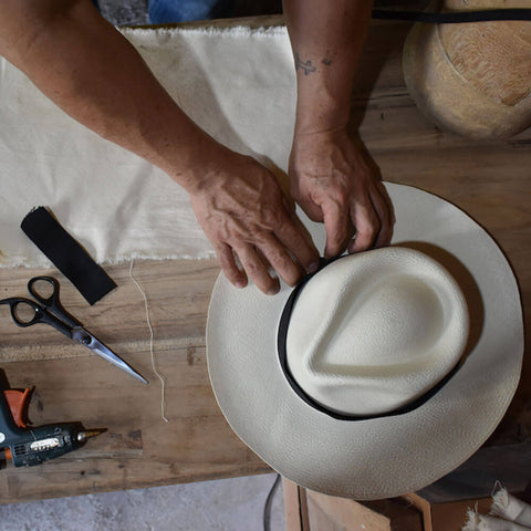 Milliner constructing a Panama hat in Ecuador