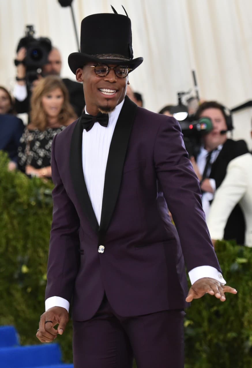 Cam Newton looks like class in this stovepipe top hat at the Met Gala, a very different style than the Slash top hat, which has curved walls and bows outward. (Photo by Mike Coppola/Getty Images for People.com)