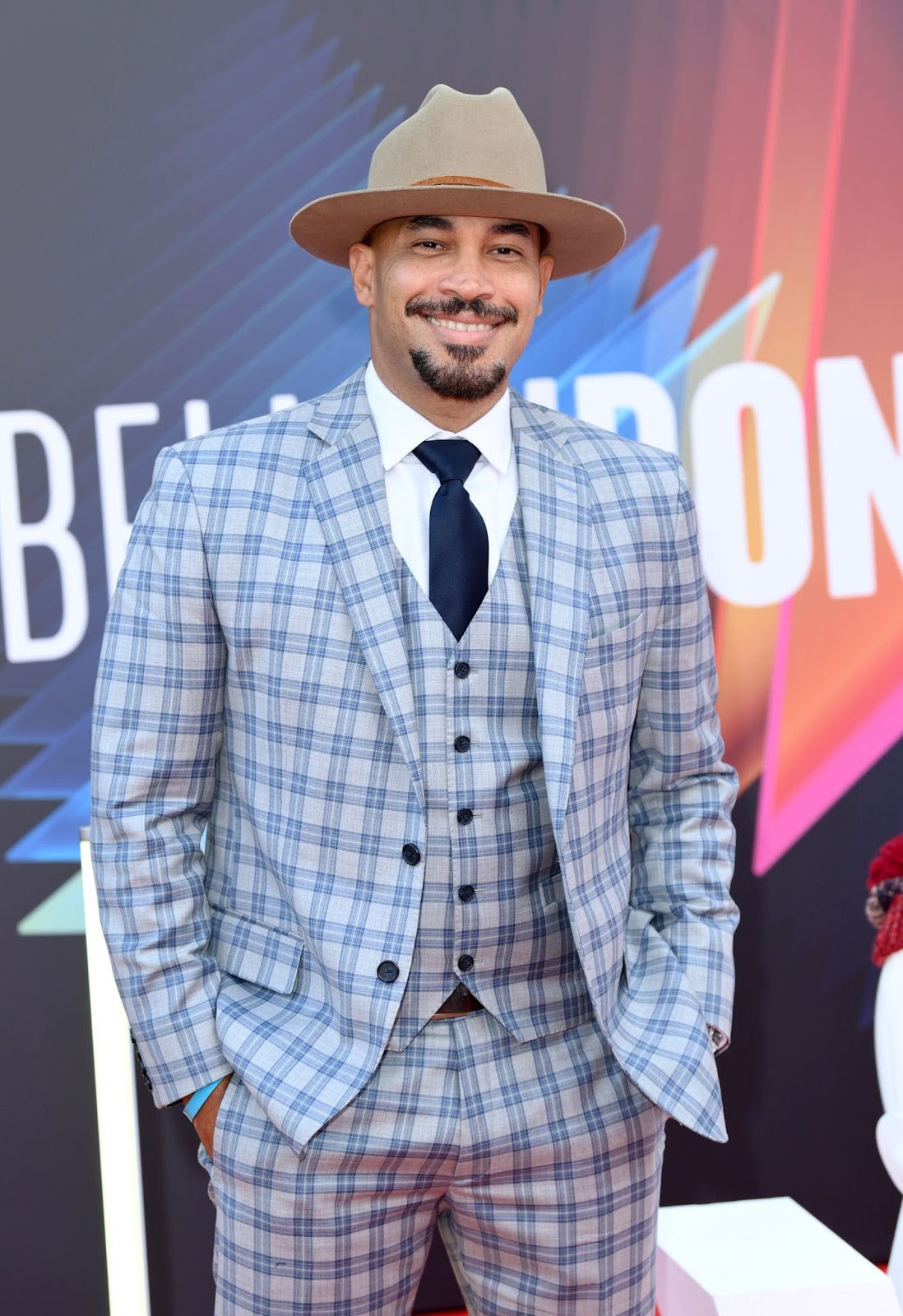 Octavio E Rodriguez wore a flat brim, tan fedora with a plaid three-piece suit at the 65th BFI London Film Festival (Karwai Tang/WireImage).
