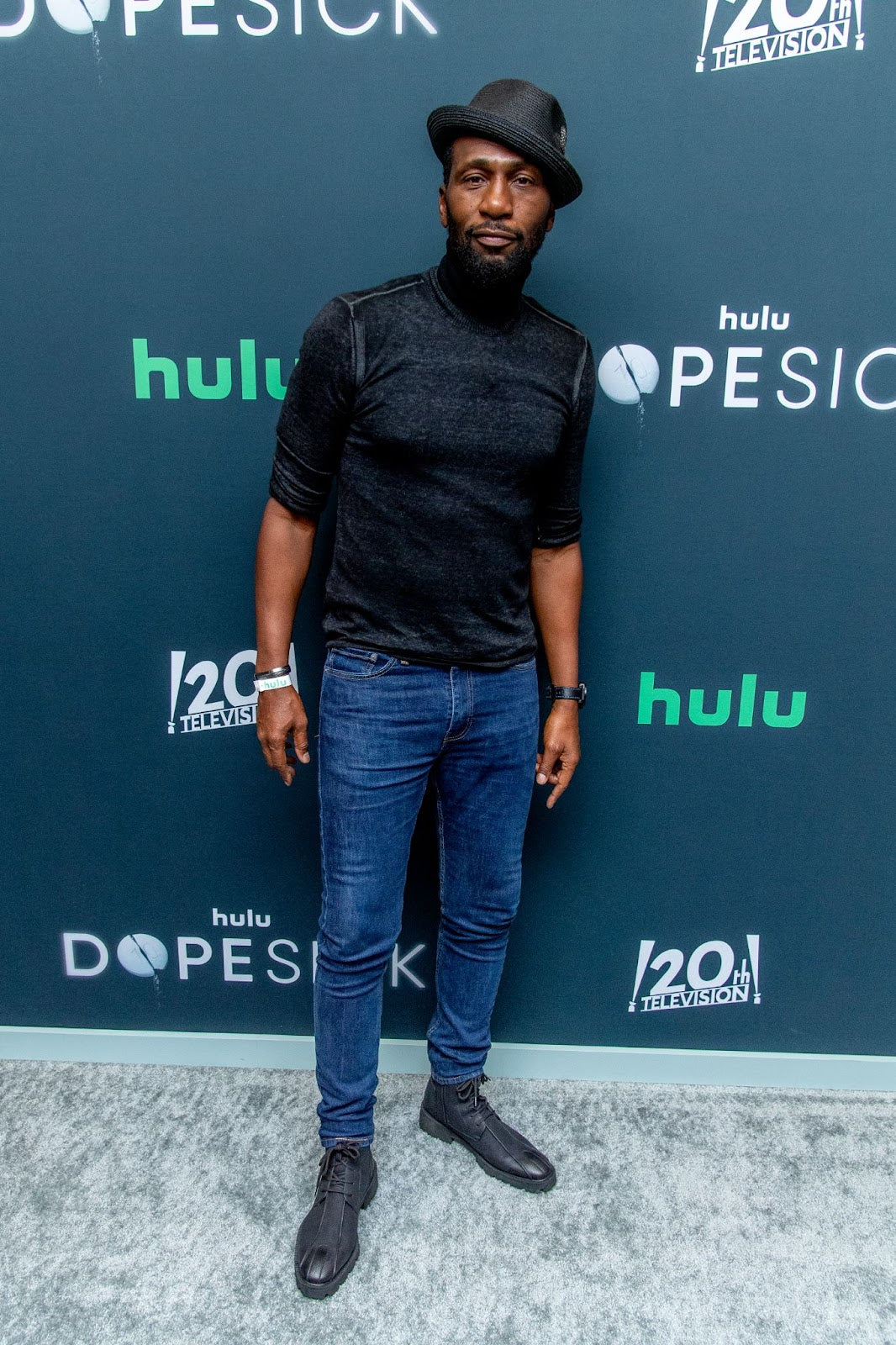 A guest wore a black men’s trilby hat with matching black sweater, watch, and boots at a Hulu premiere in New York City (Roy Rochlin/WireImage).