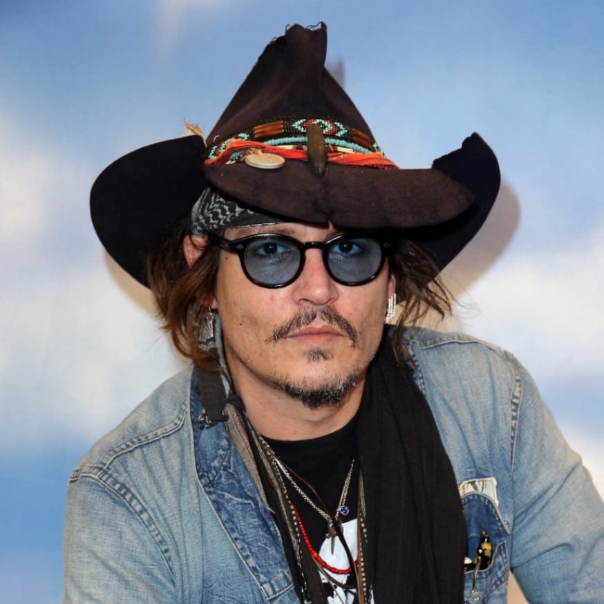 Johnny Depp wears a tattered cowboy hat to the Grammy Awards