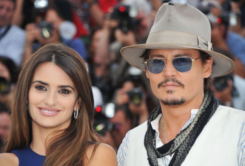 Johnny Depp wears a tattered brown fedora next to Penelope Cruz at the Cannes Film Festival