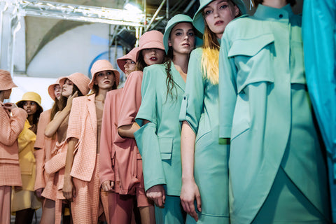 Stylish pastel-colored bucket hats with matching pantsuits.