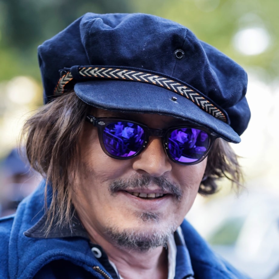 Johnny Depp wears a black fedora to the Puffins premier