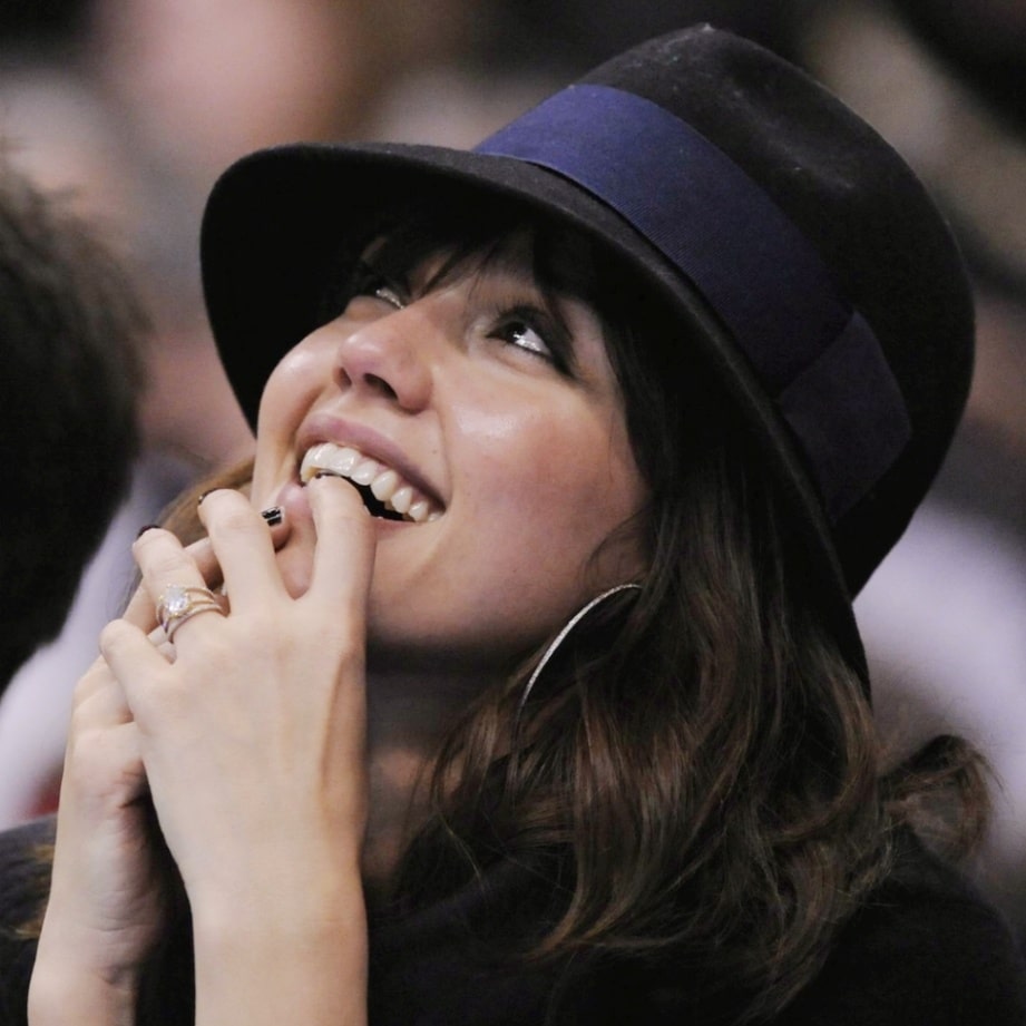 Actress Jessica Alba wears a black women’s fedora with a navy blue band as she watches the Los Angeles Clippers take on the Portland Trail Blazers at Staples Center