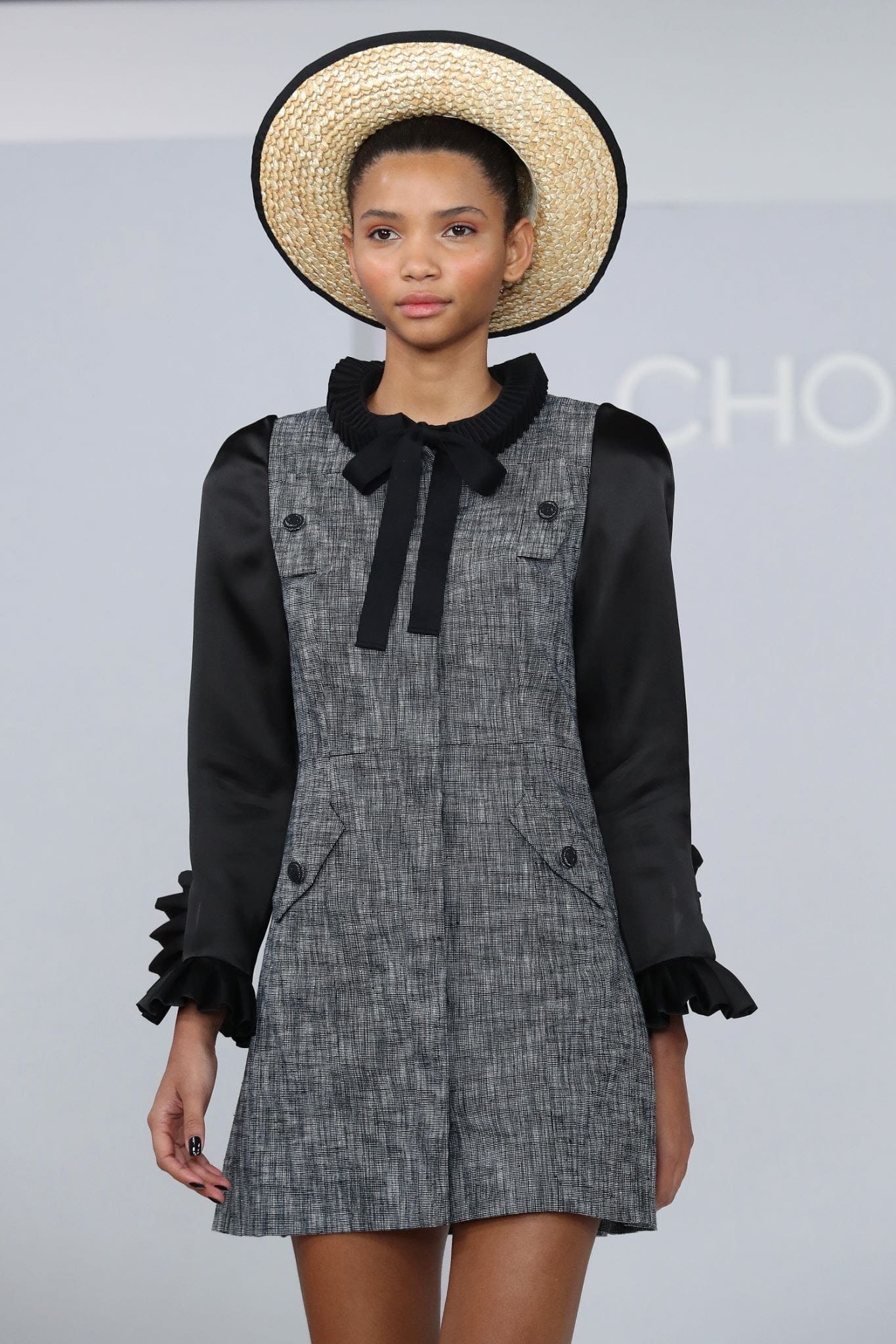 A model walks the runway in a wide-brimmed straw hat with black trim during New York Fashion Week in New York City
