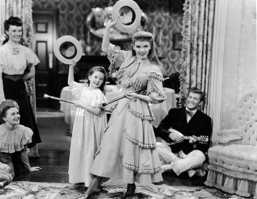 Judy Garland and Margaret O’Brien doning straw boater hats in Meet Me in St. Louis