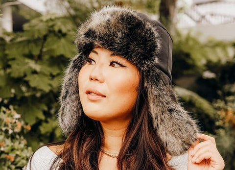A women’s trapper hat or Shapke Ushanka with the ear flaps down