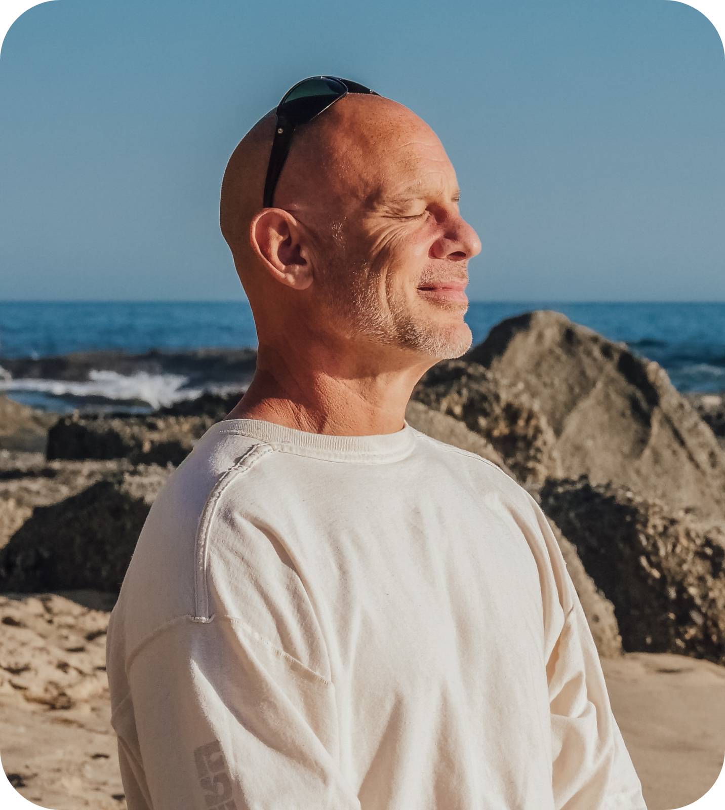 A man meditating near the sea.