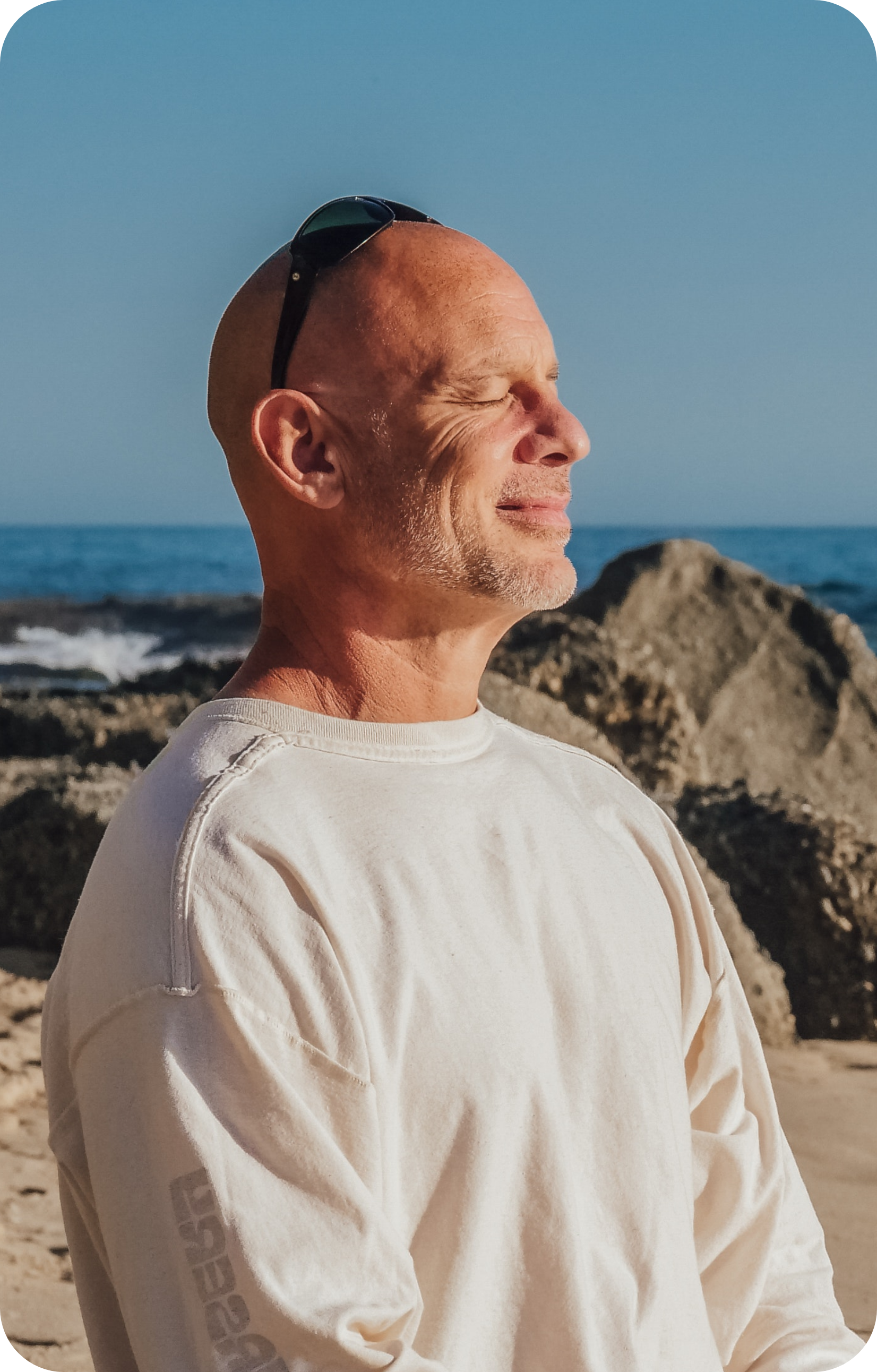 A man meditating near the sea.