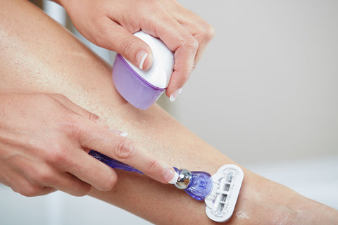 Woman shaving in combination with the Remay Shave Gel Bar-containing Tea Tree Oil