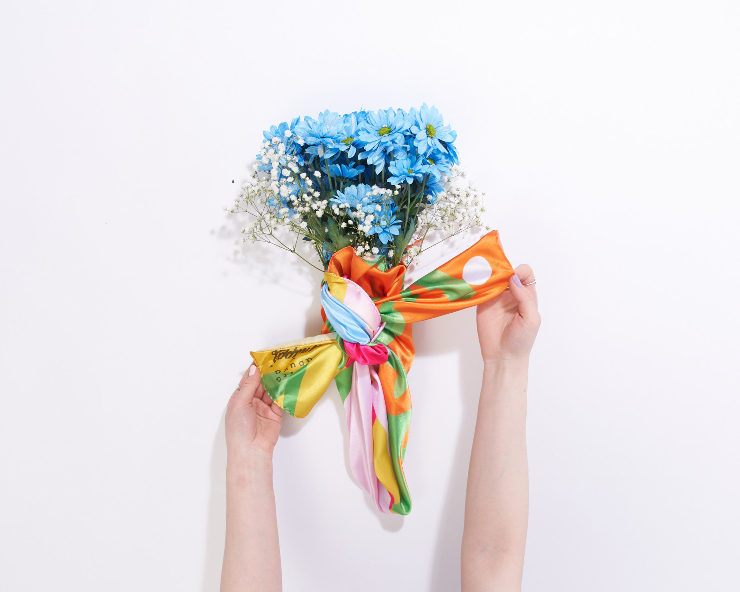 image of someone tying a double knot over top of the bouquet 