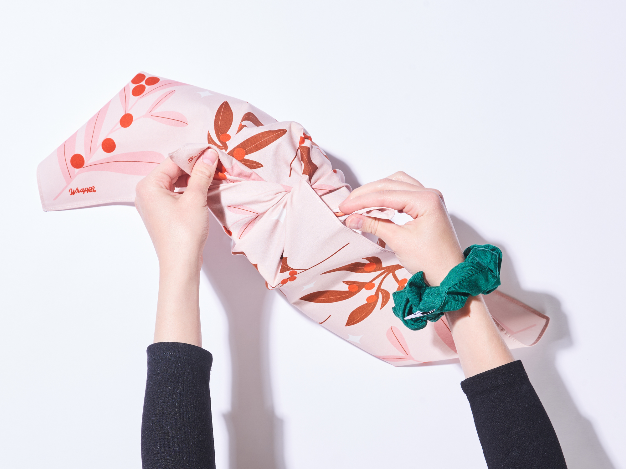 tie a single knot with two opposite corners of your furoshiki over top of your gift box