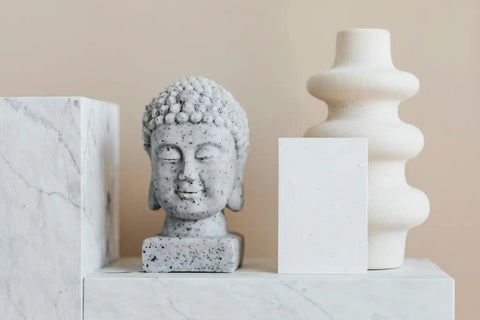 A white Buddha statue on white marble
