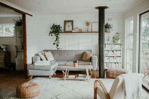 Scandinavian cultural influences in home decor with a beige couch, carpet, and shelves