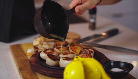 drizzling butter over scallops