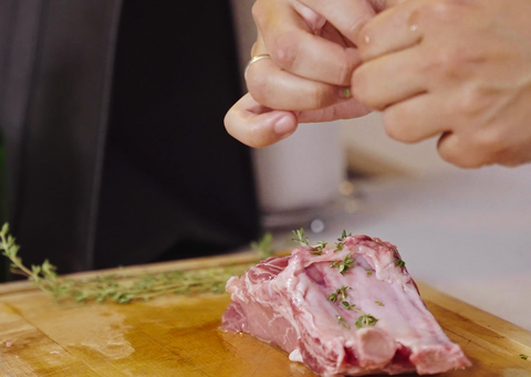 adding herbs to pork chop