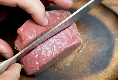 cutting the filet mignon in half