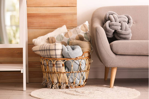 Roll up boho throw blankets and put them in a basket