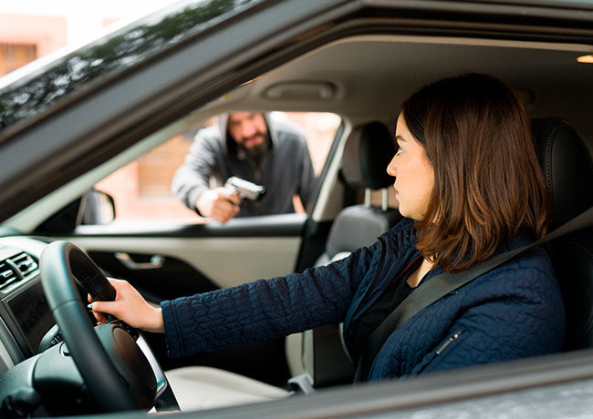  A woman driving was threatened by a man with a gun