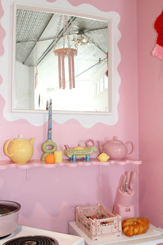 Sophie Collé's Barbiecore Aesthetic Kitchen stylings featuring unique finds from Friends NYC and her signature squiggle wall shelf.