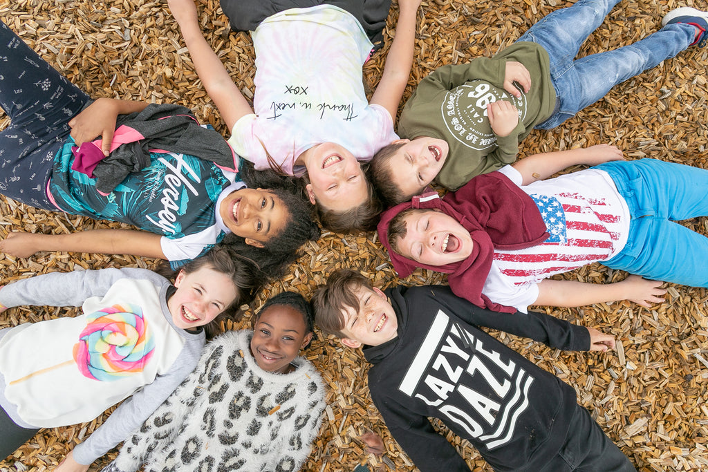 Overhead image of kids lying down in a circle