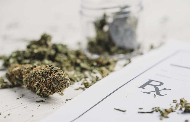 Image of dried cannabis and a prescription slip