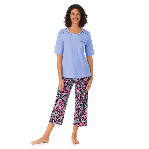 Multi Ditsy Floral; Model is wearing size S. She is 5’9”, Bust 32”, Waist 24”, Hips 34.5”. @A lady wearing a blue elbow sleeve top and cropped bottom pajama set with multi floral pattern.