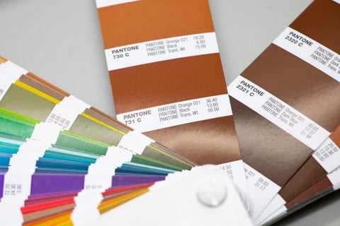 a pantone book with a brown slide out