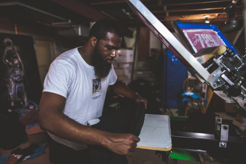 A man prints on a press