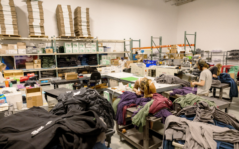 a room full of stacks of shirts