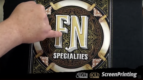 A finger points to a design that reads "FN specialties"