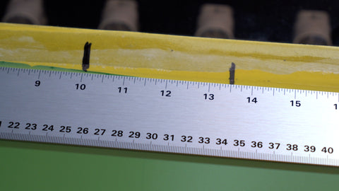 A ruler marking the center line and a line for a left chest print on a screen
