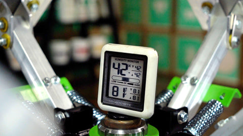 A hygrometer sits on a riley hopkins press monitoring the humidity and temperature