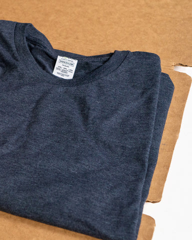 a folded t-shirt sits on a cardboard folder