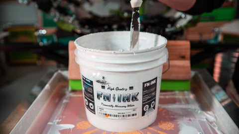 A bucket of FN-INK white ink sitting on a screen