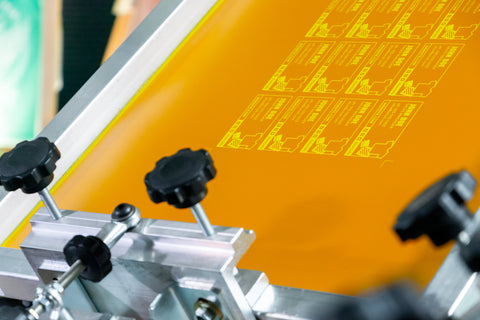 An orange screen with business cards set up in a press