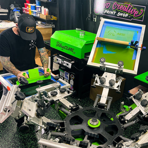 a screen printer pulls a squeegee 