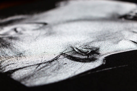 a close-up image of a woman printed in silver ink