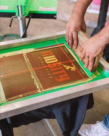 a man pulls a squeegee on a screen