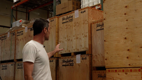 A man points at a row of boxes labeled "riley 300"