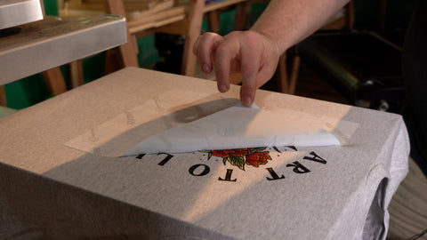 hand peeling transfer paper off print