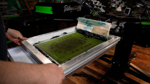 A printer holds a frame down on a platen