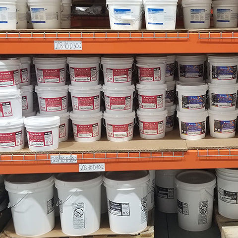 warehouse shelves full of gallons of ink