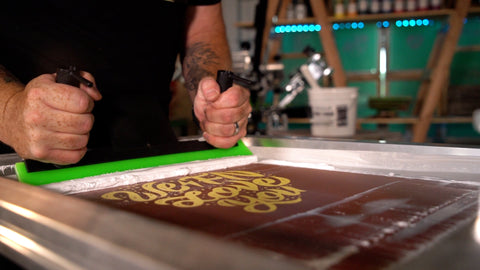 A man uses an EZ Grip squeegee on a screen