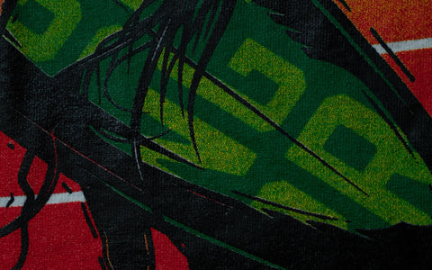 a close-up shot of a green surfboard showing the tight registration of the print